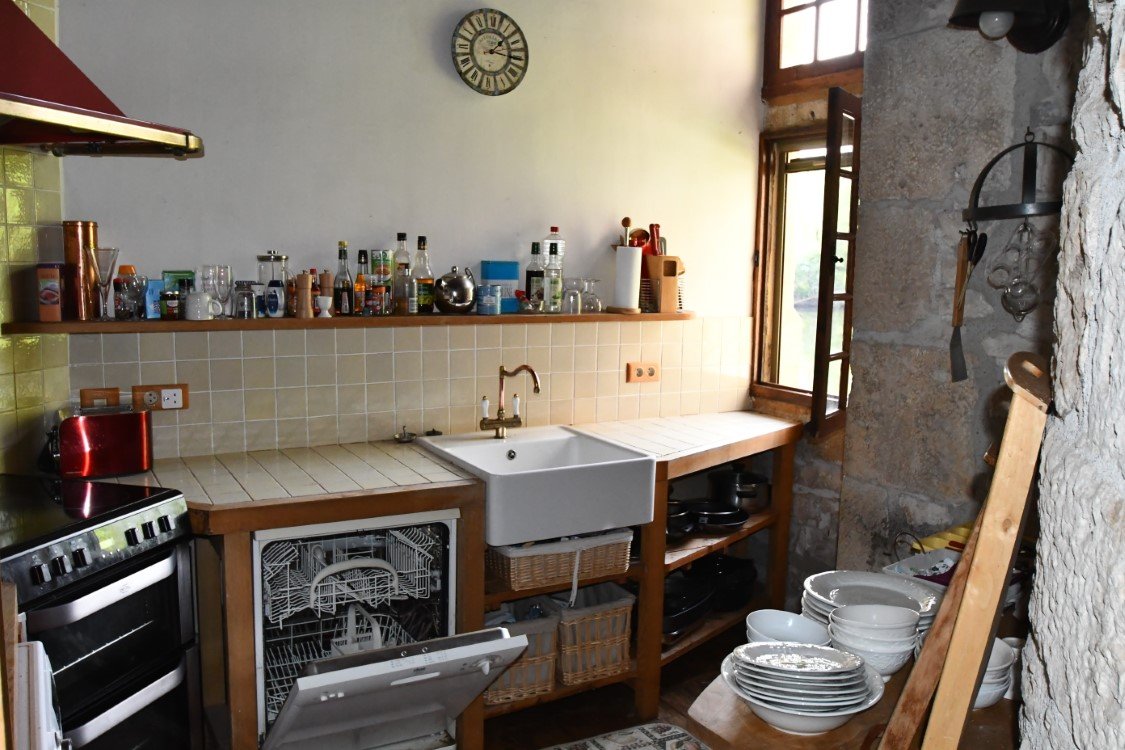 a quirky french kitching with window and a shelf full of interesting ingredients
